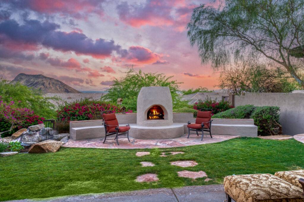 Back patio with Arizona mountain views seating with deep red outdoor cushions on the furniture