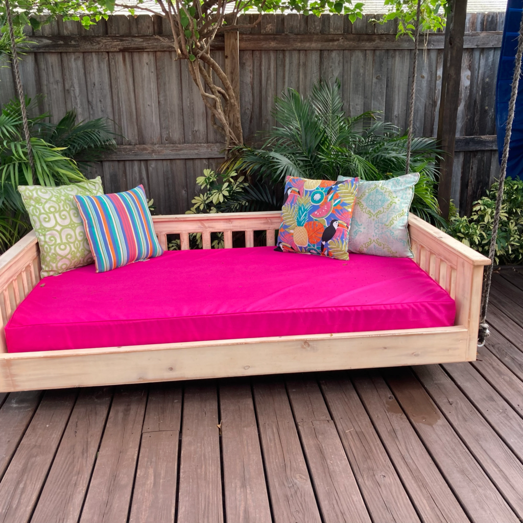 Kathleen a porch swing daybed with a water resistant mattress cover in bright magenta hue