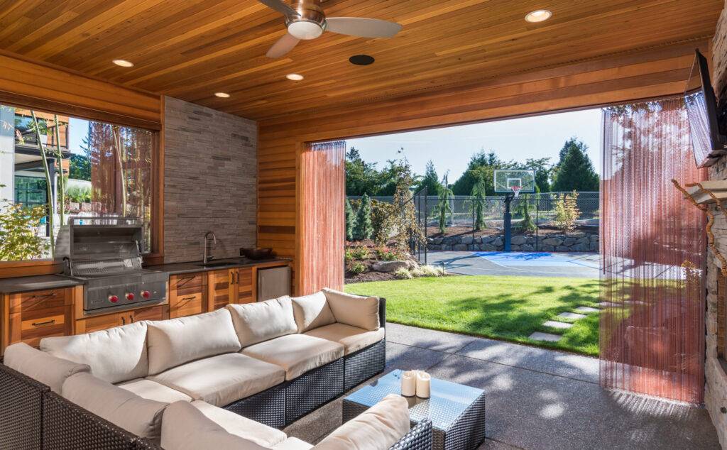 Beautiful,Covered,Patio,With,Barbecue,,Fan,,Sink,,And,Couch,,Behind