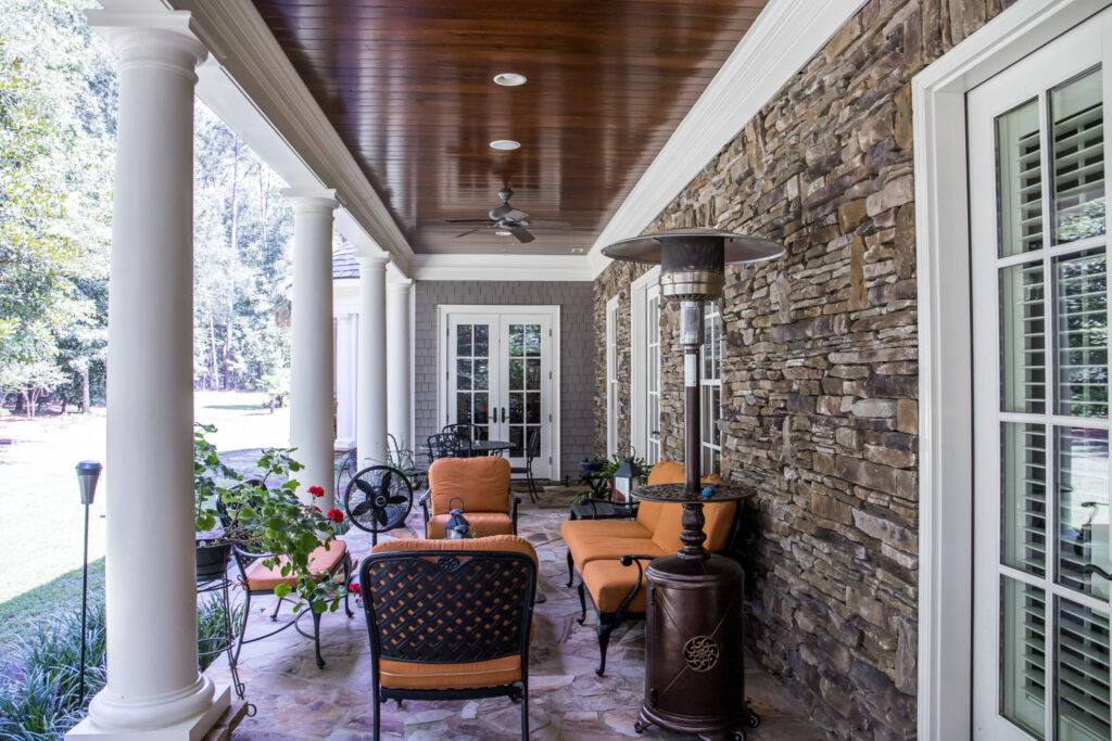 Outdoor Stone Patio Porch of large home estate with orange rust