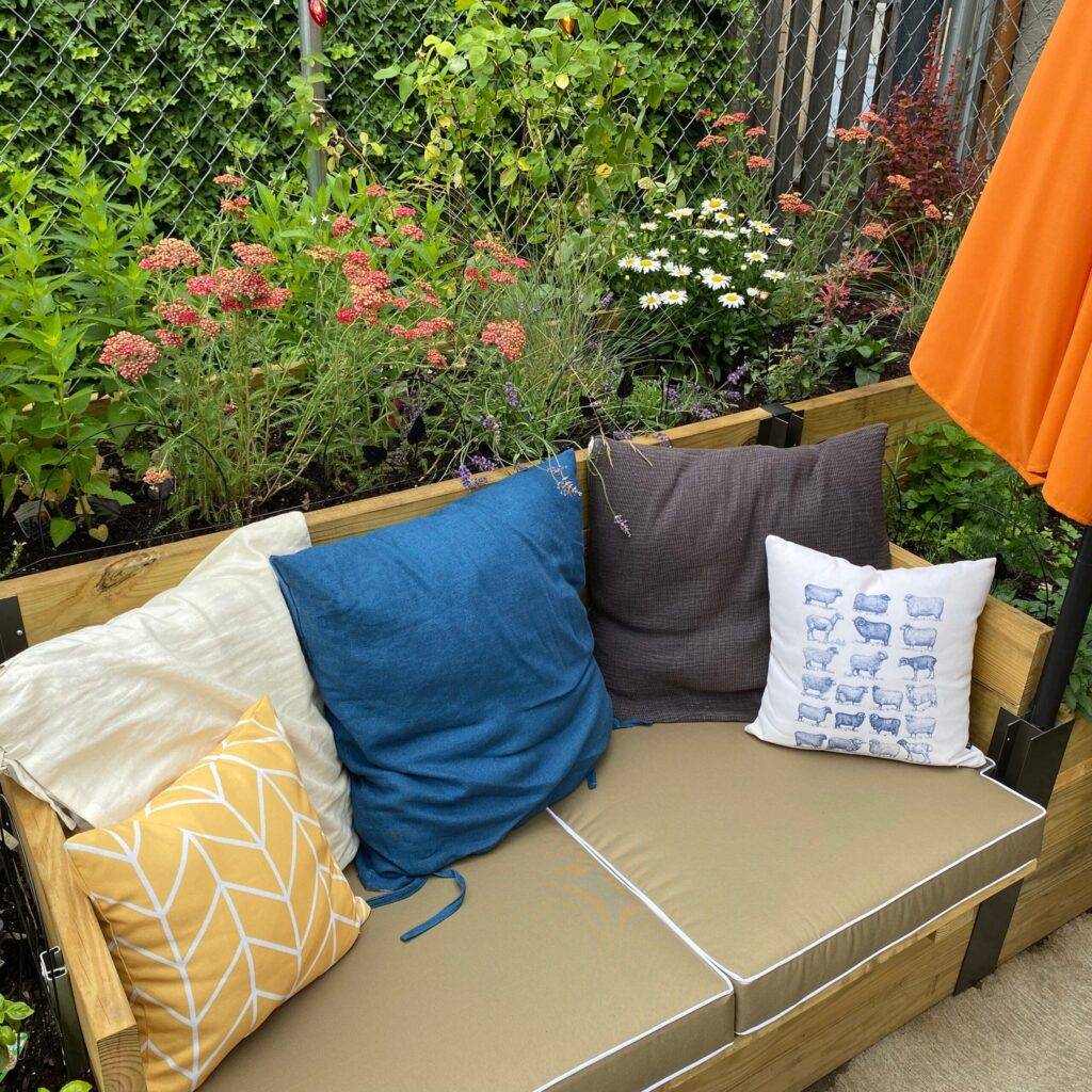 an outdoor bed styled with waterproof mattress in latte color with contrast piping
