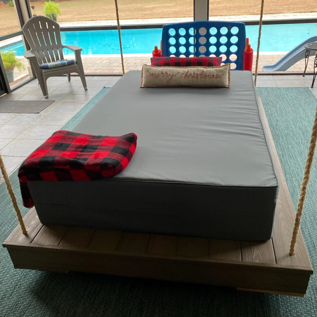 A photo from a customer showing a perfectly fitted, crisp-cornered daybed cover on a porch swing